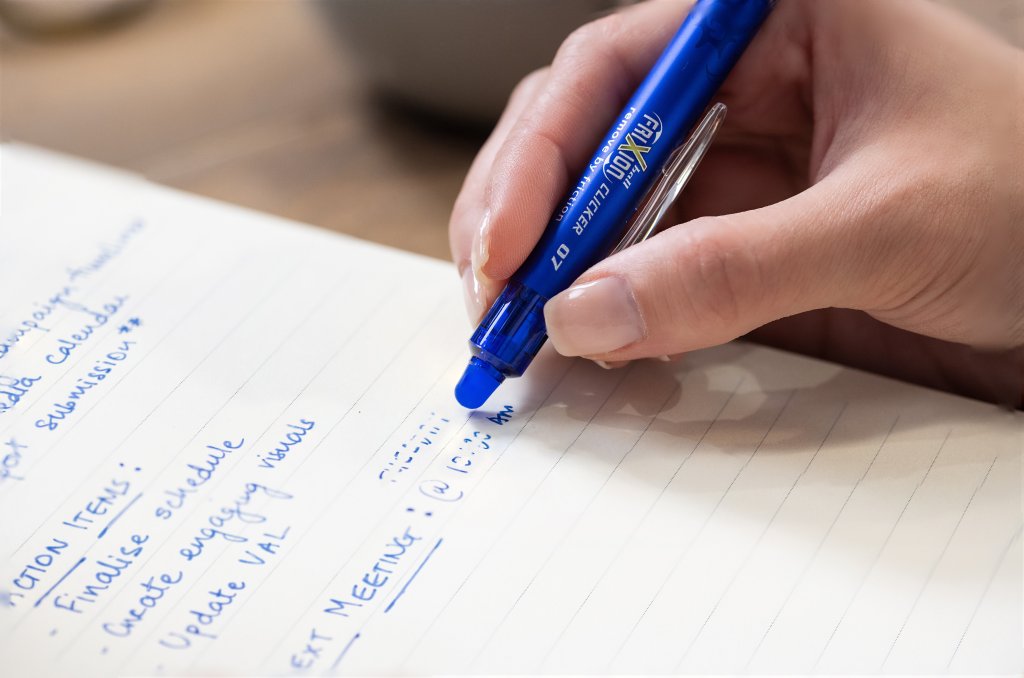 Pilot FriXion Clicker Erasable Pen in blue erasing a to-do list, showcasing how erasable pens work.