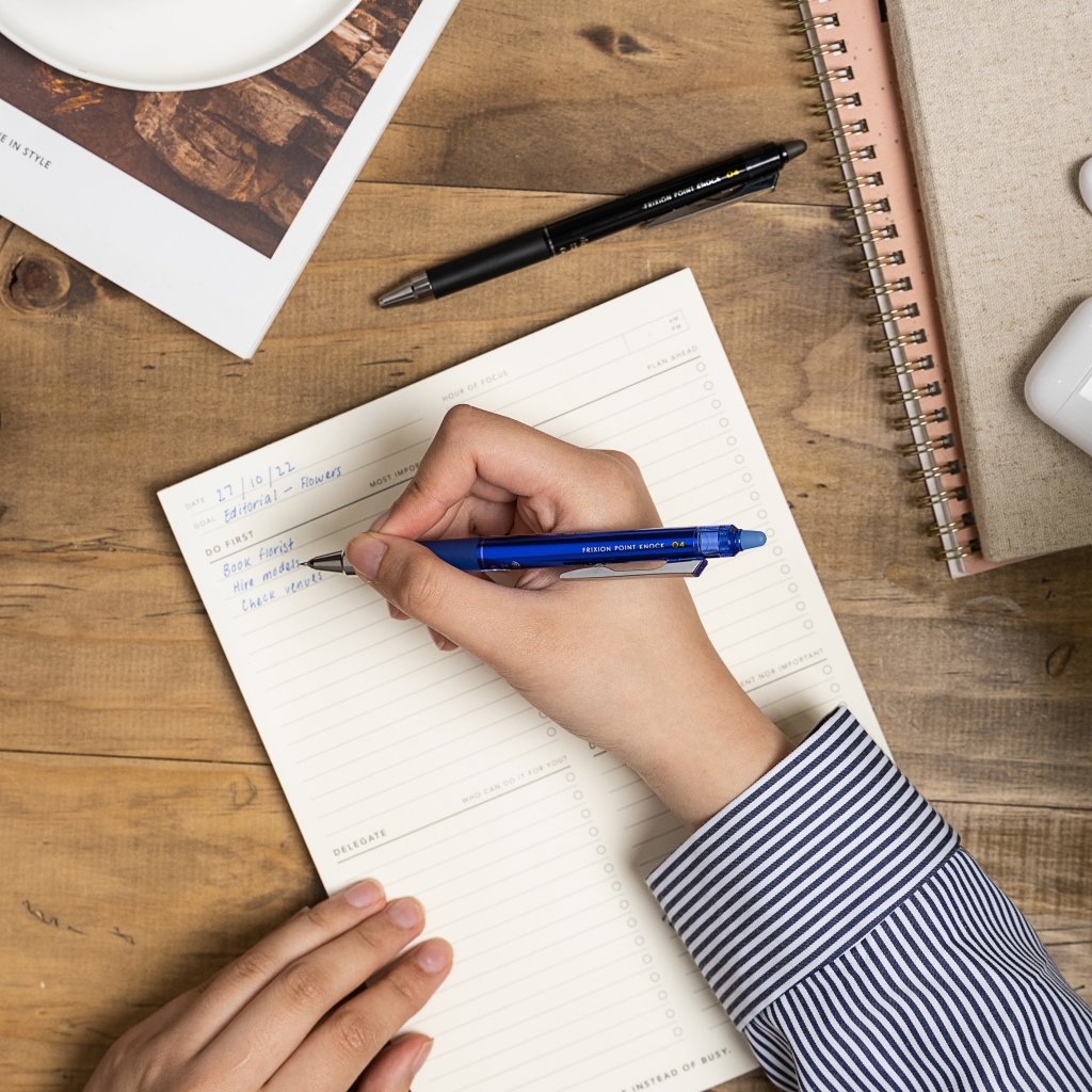 PILOT Pen FriXion Point Knock 0.4 Gel Pen 0.4mm in blue, writing a to-do list on a desk.